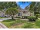 Beautiful home exterior with manicured lawn and driveway with parked vehicle at 15314 Sherwood Forest Dr, Tampa, FL 33647