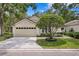 Charming home featuring a manicured front yard and a two-car garage at 15314 Sherwood Forest Dr, Tampa, FL 33647