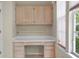 Bright home office space featuring built-in desk, cabinets, and natural light from the window at 15314 Sherwood Forest Dr, Tampa, FL 33647