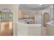 A kitchen featuring white appliances, wood cabinets, tile floors, and bar seating area at 15314 Sherwood Forest Dr, Tampa, FL 33647