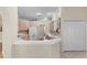 A kitchen with white cabinets and appliances, complemented by tile floors and a breakfast bar at 15314 Sherwood Forest Dr, Tampa, FL 33647