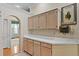 Kitchen showcasing wood cabinets, white countertops, and direct access to another room at 15314 Sherwood Forest Dr, Tampa, FL 33647