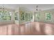 Inviting living room with hardwood floors, large windows, and natural light at 15314 Sherwood Forest Dr, Tampa, FL 33647