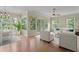 Bright living room featuring hardwood floors, ceiling fan, and ample natural light at 15314 Sherwood Forest Dr, Tampa, FL 33647
