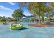 Community playground featuring a variety of colorful play structures and seating areas for families at 15314 Sherwood Forest Dr, Tampa, FL 33647