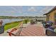 Serene back patio offers outdoor seating and scenic views of the tranquil lake at 15426 Wicked Strong St, Sun City Center, FL 33573