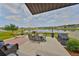 Charming back patio with beautiful lake view, perfect for outdoor relaxing and entertaining at 15426 Wicked Strong St, Sun City Center, FL 33573