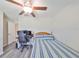 Bedroom with a ceiling fan and desk, creating a functional and inviting space at 15426 Wicked Strong St, Sun City Center, FL 33573