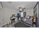 This bedroom features a ceiling fan, a window, and light gray plank flooring at 15426 Wicked Strong St, Sun City Center, FL 33573