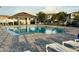 Enjoy this beautiful community pool with a covered seating area, lounge chairs, and sparkling clear water at 15426 Wicked Strong St, Sun City Center, FL 33573