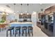 A kitchen with island seating, granite counters, dark cabinetry, and stainless steel appliances; an ideal eat-in space at 15426 Wicked Strong St, Sun City Center, FL 33573