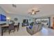 Inviting living room with a comfortable seating area, a large television, and tranquil water views at 15426 Wicked Strong St, Sun City Center, FL 33573
