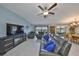 Comfortable living room with a ceiling fan, fireplace, and view of the water at 15426 Wicked Strong St, Sun City Center, FL 33573