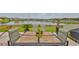 Inviting patio dining area with outdoor seating overlooking a picturesque lake view at 15426 Wicked Strong St, Sun City Center, FL 33573