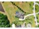Aerial of luxury home with screened-in pool, paver driveway, and meticulously landscaped yard at 17305 Ballmont Park Dr, Odessa, FL 33556