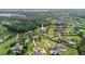 Stunning aerial view of a luxury home surrounded by lush landscaping and greenery at 17305 Ballmont Park Dr, Odessa, FL 33556