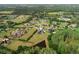 Aerial view of a luxury home situated on a large lot with mature trees and a pond at 17305 Ballmont Park Dr, Odessa, FL 33556
