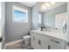 This bathroom features a large mirror, a window, and a white vanity at 17305 Ballmont Park Dr, Odessa, FL 33556