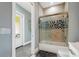 Bathroom with a glass shower, sliding shower door, and decorative tile detail at 17305 Ballmont Park Dr, Odessa, FL 33556