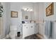 Bathroom featuring white cabinets, neutral colored walls, and accent paintings at 17305 Ballmont Park Dr, Odessa, FL 33556