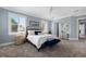 Serene bedroom features a neutral color palette, large windows, and stylish furnishings at 17305 Ballmont Park Dr, Odessa, FL 33556