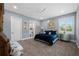 Bedroom featuring carpet, accent art, blue walls, and a large window at 17305 Ballmont Park Dr, Odessa, FL 33556