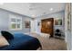 This bedroom features a large window, an antique wardrobe, and colorful art at 17305 Ballmont Park Dr, Odessa, FL 33556
