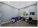 Cozy bedroom with bright window, small desk, and carpeted floors at 17305 Ballmont Park Dr, Odessa, FL 33556