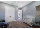 This bedroom features a crib and closet with neutral walls and plush carpeting at 17305 Ballmont Park Dr, Odessa, FL 33556