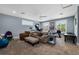 Spacious bonus room features two windows, comfortable seating, and fitness equipment at 17305 Ballmont Park Dr, Odessa, FL 33556