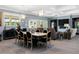 Open-concept dining area flows into the living room, with elegant lighting and access to the screened lanai at 17305 Ballmont Park Dr, Odessa, FL 33556