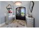 Elegant foyer with a decorative light fixture, stylish mirrors, and beautiful flooring at 17305 Ballmont Park Dr, Odessa, FL 33556