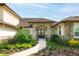 Charming front entrance with beautiful landscaping, stone accents, and a paved walkway leading to the elegant front door at 17305 Ballmont Park Dr, Odessa, FL 33556