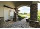Charming front porch with stone columns and decorative rug offers a welcoming entry at 17305 Ballmont Park Dr, Odessa, FL 33556