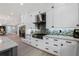 Bright kitchen with white cabinets, stainless steel appliances, granite countertops, and a decorative tile backsplash at 17305 Ballmont Park Dr, Odessa, FL 33556