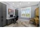 Well-lit office features gray built-in cabinets, a modern desk, and a neutral-toned rug at 17305 Ballmont Park Dr, Odessa, FL 33556