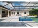 The backyard pool is encased in a screen and features a hot tub and outdoor seating at 17305 Ballmont Park Dr, Odessa, FL 33556