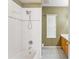 Clean bathroom with a white tiled shower and a window at 17812 Arbor Greene Dr, Tampa, FL 33647