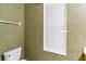 Bathroom featuring a toilet and patterned wallpaper at 17812 Arbor Greene Dr, Tampa, FL 33647