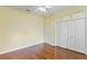 A bedroom featuring hardwood floors, closet and shelves at 17812 Arbor Greene Dr, Tampa, FL 33647