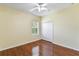 A bedroom featuring hardwood floors, a ceiling fan and a window at 17812 Arbor Greene Dr, Tampa, FL 33647