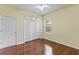 A bedroom with hardwood floors and a double door closet at 17812 Arbor Greene Dr, Tampa, FL 33647