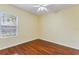 Bedroom with hardwood floors and natural light from the window at 17812 Arbor Greene Dr, Tampa, FL 33647