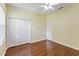 Bedroom with hardwood floors, ceiling fan, and closet at 17812 Arbor Greene Dr, Tampa, FL 33647