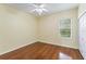Bedroom featuring hardwood floors, a ceiling fan, a window, and a closet, offering practical space at 17812 Arbor Greene Dr, Tampa, FL 33647