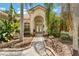 Charming front entrance featuring tiled roof, double doors, arched entryway, and lush landscaping at 17812 Arbor Greene Dr, Tampa, FL 33647