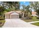 Charming home with a well-manicured lawn, lovely landscaping, and a two-car garage at 17812 Arbor Greene Dr, Tampa, FL 33647
