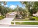 Charming home with a well-manicured lawn, lovely landscaping, and a two-car garage at 17812 Arbor Greene Dr, Tampa, FL 33647
