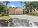 Spacious property featuring a three-car garage, driveway, lush landscaping, and a terracotta tiled roof at 17812 Arbor Greene Dr, Tampa, FL 33647