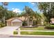 Charming home with a well-manicured lawn, lovely landscaping, and a two-car garage at 17812 Arbor Greene Dr, Tampa, FL 33647
